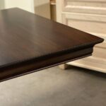 “Close-up of smooth oak tabletop grain and beveled edge on Royal dining table