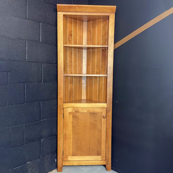 Tall Wooden Corner Cabinet Featuring Open Display Shelves On Top And A Lower Cupboard Door.